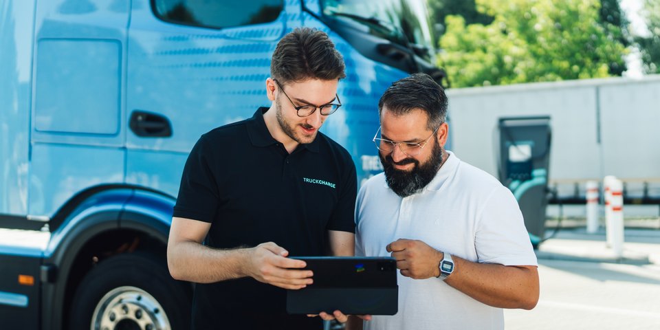 Two persons checking digital eServices via a tablet