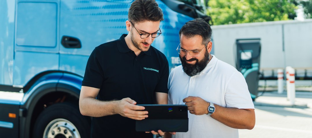Two persons checking digital eServices via a tablet