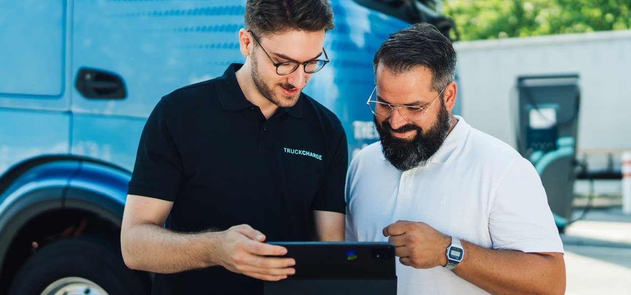 Two persons checking digital eServices via a tablet