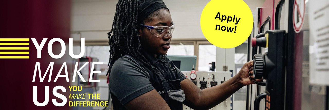 An employee in work clothes and safety goggles concentrates on operating a CNC machine in a factory hall, with the slogan "YOU MAKE US - YOU MAKE THE DIFFERENCE" and an "Apply now!" button.