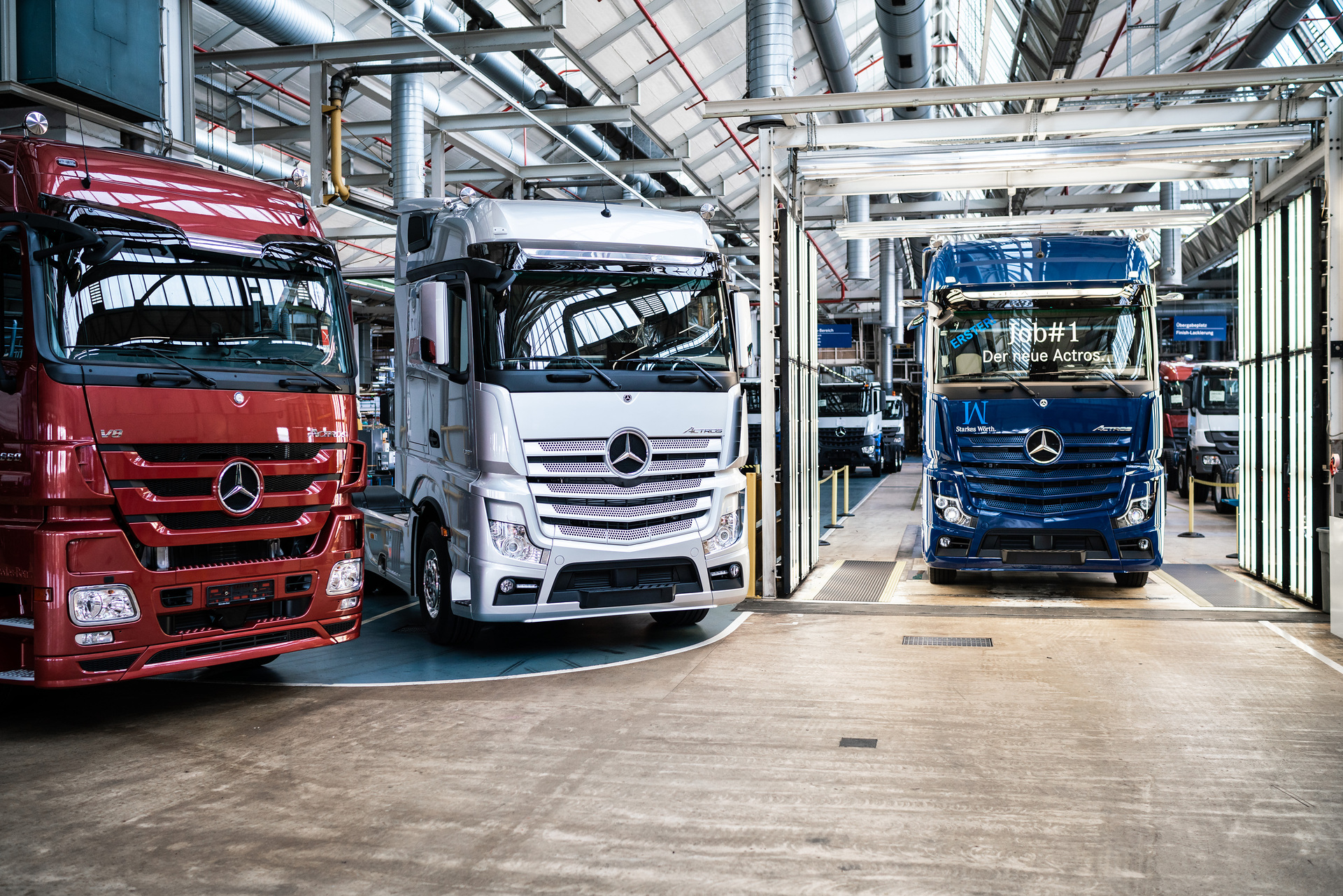 A milestone at the Mercedes-Benz plant in Wörth: The first new Mercedes-Benz Actros in sapphire-blue next to its predecessor (in silver) and its predecessor before (in red) is ready for its customer. Job #1 of the Mercedes-Benz Trucks flagship: Ready for its customers: the first new Actros rolls off the production line at the Mercedes-Benz Wörth plant