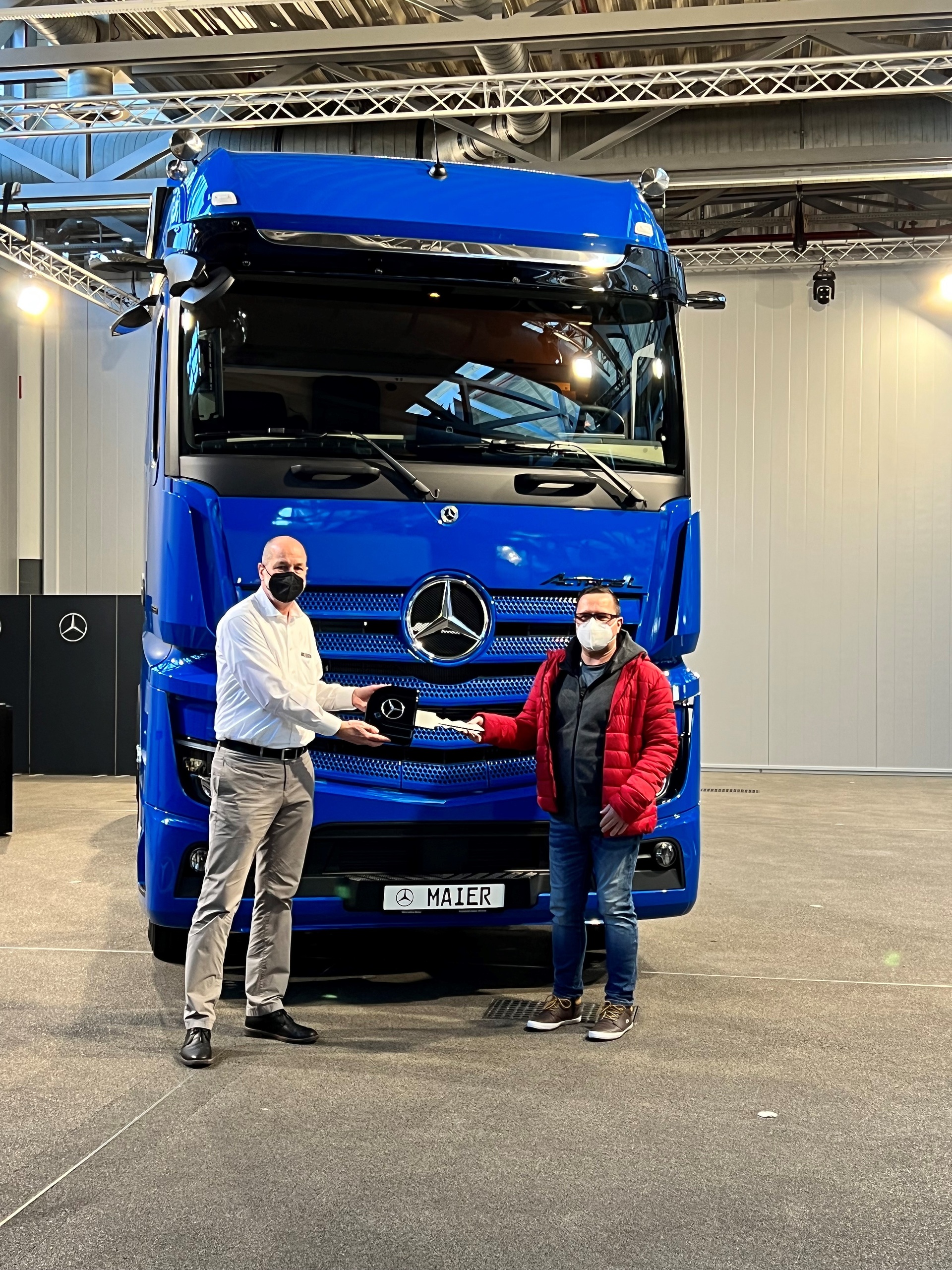Reiner Scherer aus dem Kundencenter Wörth (links) und Thomas Maier Geschäftsführer der Gebrüder Maier GmbH (rechts) Extra-Klasse in enzianblau: Erster Actros L für die Gebrüder Maier GmbH