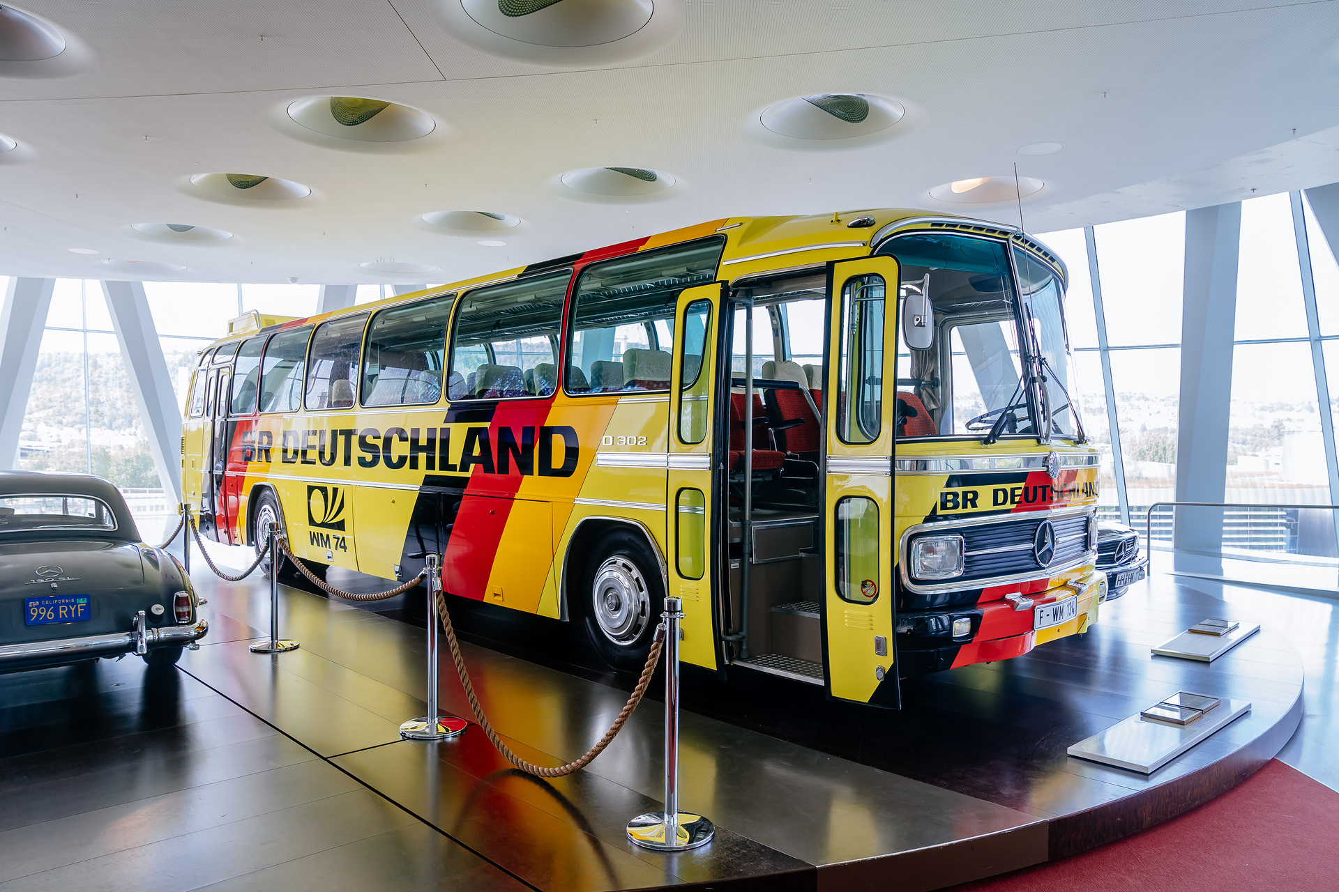 Mercedes-Benz Museum, Raum Collection 4: Galerie der Namen, Reisebus Mercedes-Benz O 302 der westdeutschen Fußballnationalmannschaft während der Weltmeisterschaft von 1974. Ansicht von schräg rechts vorn. Höchster Buskomfort für die WM-Fußballer 1974