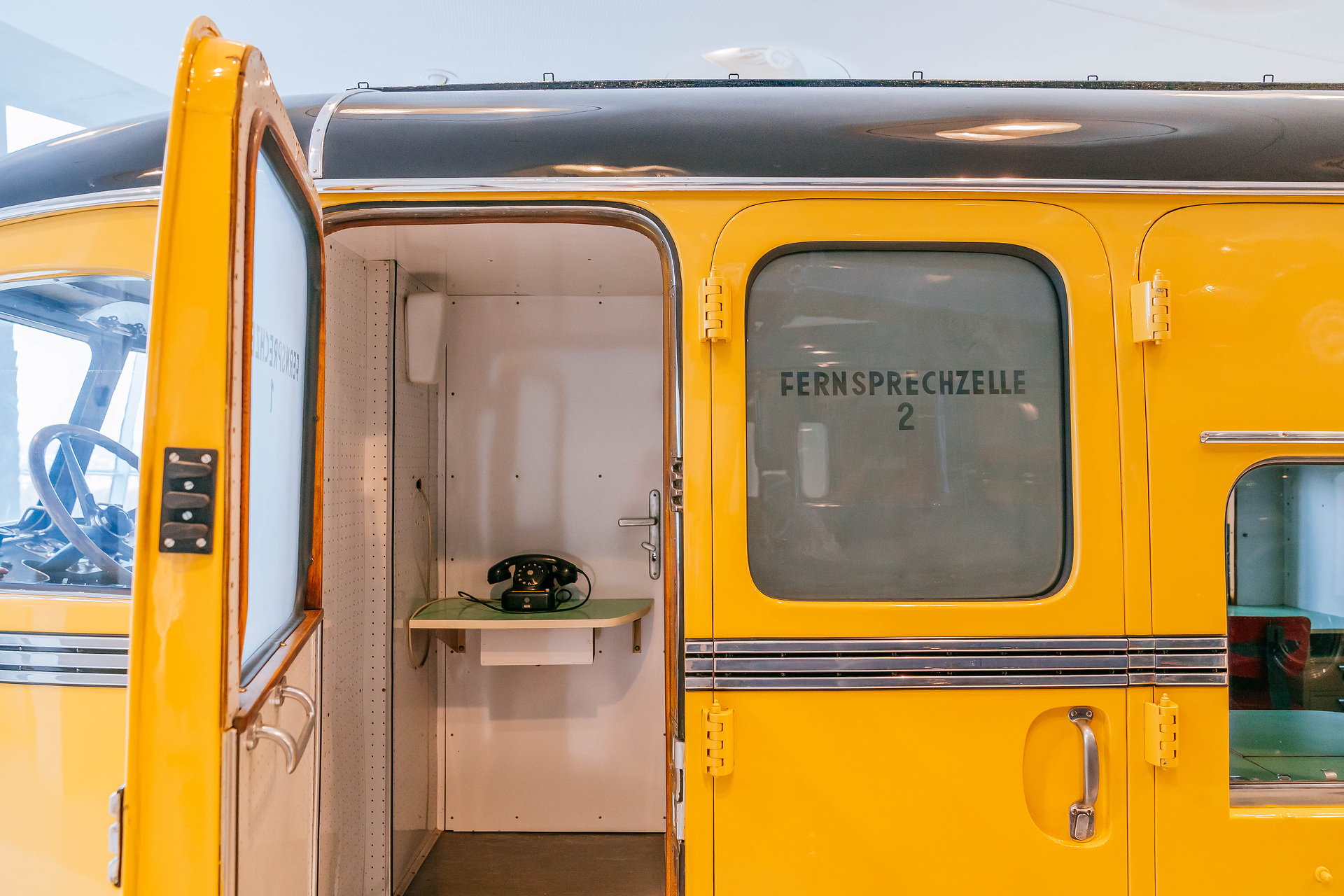 Mercedes-Benz Museum, Raum Collection 2: Galerie der Lasten. Mercedes-Benz Omnibus O 10000 aus dem Jahr 1938, umgebaut als mobiles Postamt der Österreichischen Post. Fernsprechzellen 1 und 2 auf der linken Fahrzeugseite. In diesem Mercedes-Benz Omnibus geht bis in die 1970er-Jahre die Post ab