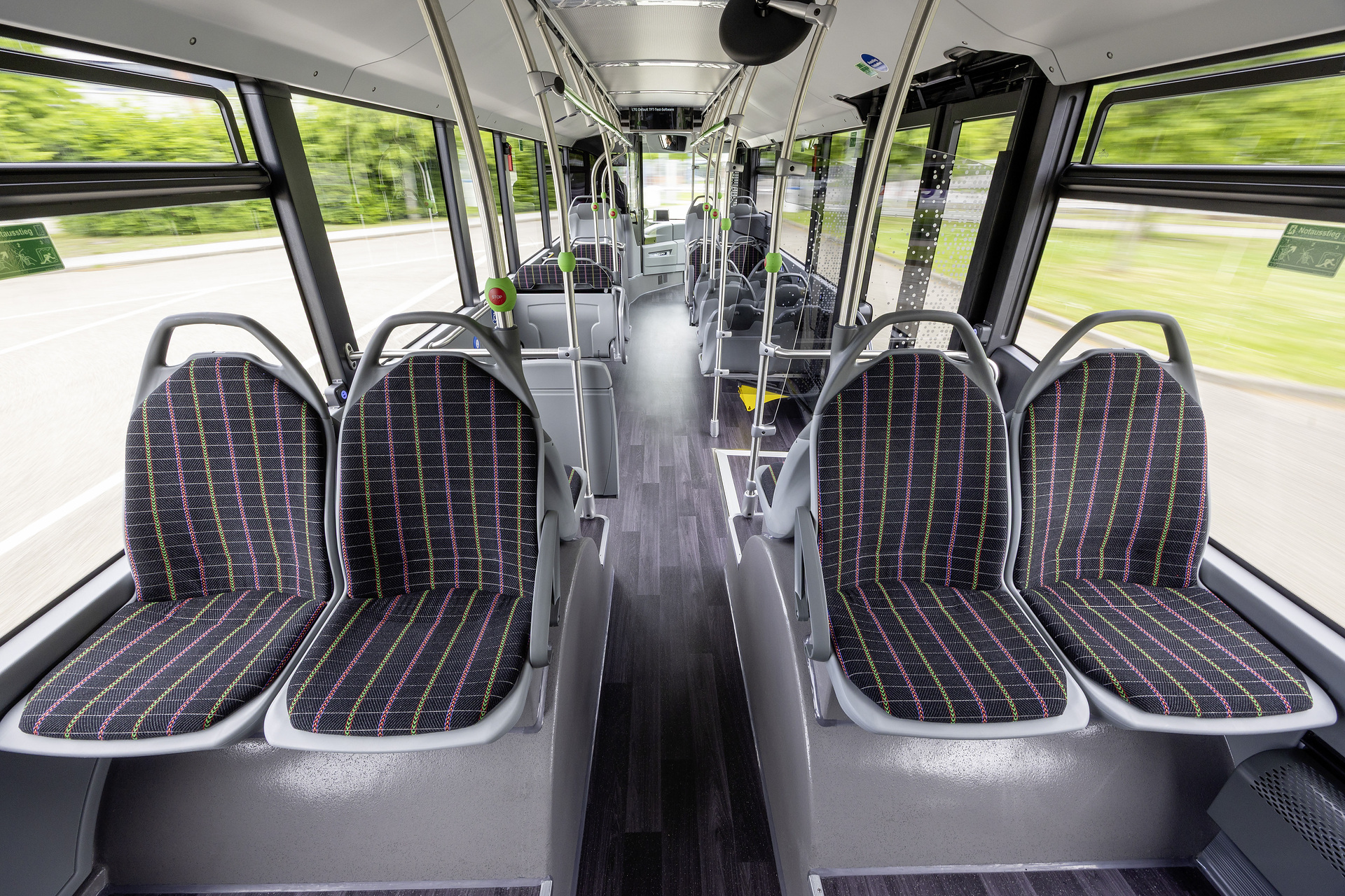 Mercedes-Benz eCitaro with all-electric drive, NMC 4 battery, interior, Seat covers: black with colorful stripes, 2 x electric hub motor, 2 x 140 kW, 2 x 495 Nm, 5 battery packs with 111 kWh each, LED headlamps, Sideguard Assist 2, Preventive Brake Assist 2, Frontguard Assist, Attention Assist, Traffic Sign Assist, 360 degree camera, length/width/height: 12135/2550/3400 mm, passenger capacity: 1/88. Mercedes-Benz, Daimler Buses Solutions and Omniplus in Hamburg: Daimler Buses at the UITP Summit 2025