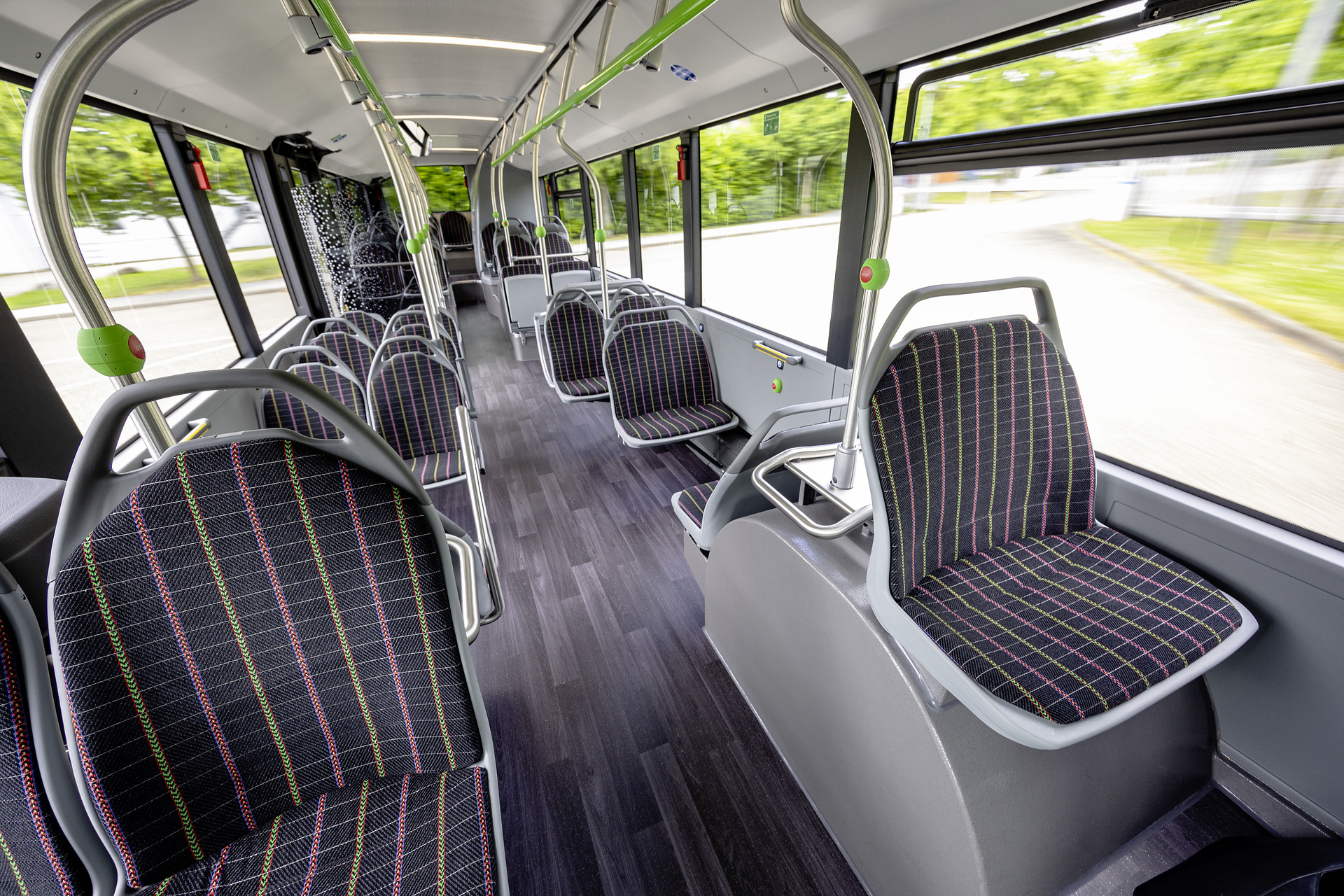Mercedes-Benz eCitaro with all-electric drive, NMC 4 battery, interior, Seat covers: black with colorful stripes, 2 x electric hub motor, 2 x 140 kW, 2 x 495 Nm, 5 battery packs with 111 kWh each, LED headlamps, Sideguard Assist 2, Preventive Brake Assist 2, Frontguard Assist, Attention Assist, Traffic Sign Assist, 360 degree camera, length/width/height: 12135/2550/3400 mm, passenger capacity: 1/88. Mercedes-Benz, Daimler Buses Solutions and Omniplus in Hamburg: Daimler Buses at the UITP Summit 2025