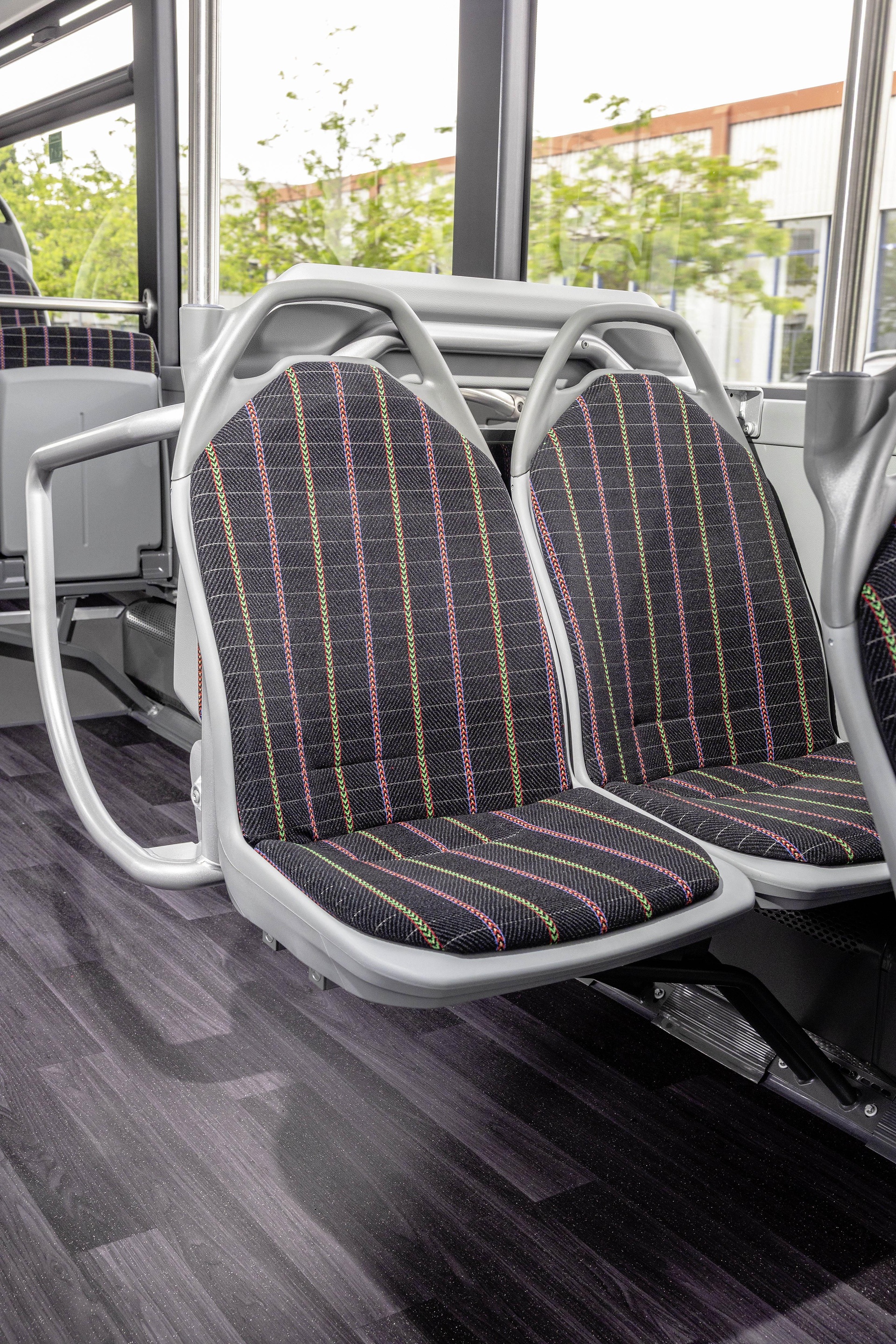 Mercedes-Benz eCitaro with all-electric drive, NMC 4 battery, interior, Seat covers: black with colorful stripes, 2 x electric hub motor, 2 x 140 kW, 2 x 495 Nm, 5 battery packs with 111 kWh each, LED headlamps, Sideguard Assist 2, Preventive Brake Assist 2, Frontguard Assist, Attention Assist, Traffic Sign Assist, 360 degree camera, length/width/height: 12135/2550/3400 mm, passenger capacity: 1/88. Mercedes-Benz, Daimler Buses Solutions and Omniplus in Hamburg: Daimler Buses at the UITP Summit 2025
