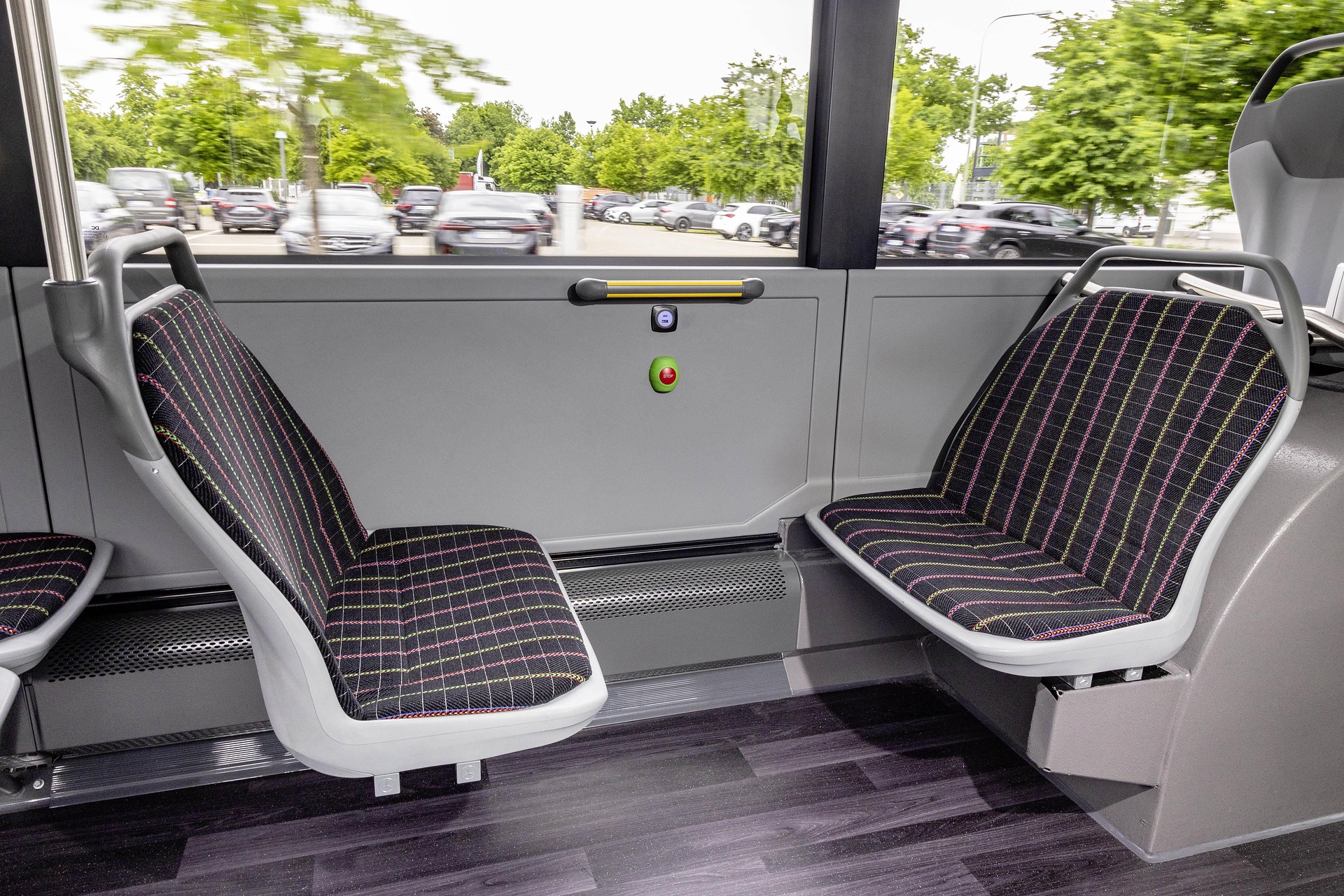 Mercedes-Benz eCitaro with all-electric drive, NMC 4 battery, interior, Seat covers: black with colorful stripes, 2 x electric hub motor, 2 x 140 kW, 2 x 495 Nm, 5 battery packs with 111 kWh each, LED headlamps, Sideguard Assist 2, Preventive Brake Assist 2, Frontguard Assist, Attention Assist, Traffic Sign Assist, 360 degree camera, length/width/height: 12135/2550/3400 mm, passenger capacity: 1/88. Mercedes-Benz, Daimler Buses Solutions and Omniplus in Hamburg: Daimler Buses at the UITP Summit 2025