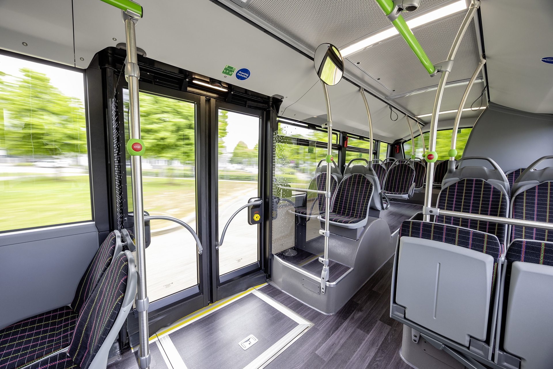 Mercedes-Benz eCitaro with all-electric drive, NMC 4 battery, interior, Seat covers: black with colorful stripes, 2 x electric hub motor, 2 x 140 kW, 2 x 495 Nm, 5 battery packs with 111 kWh each, LED headlamps, Sideguard Assist 2, Preventive Brake Assist 2, Frontguard Assist, Attention Assist, Traffic Sign Assist, 360 degree camera, length/width/height: 12135/2550/3400 mm, passenger capacity: 1/88. Mercedes-Benz, Daimler Buses Solutions and Omniplus in Hamburg: Daimler Buses at the UITP Summit 2025